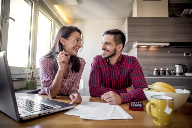 Couple happily having a conversation over paperwork