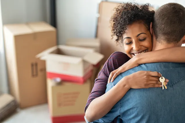 Couple Hugging Holding Home Keys