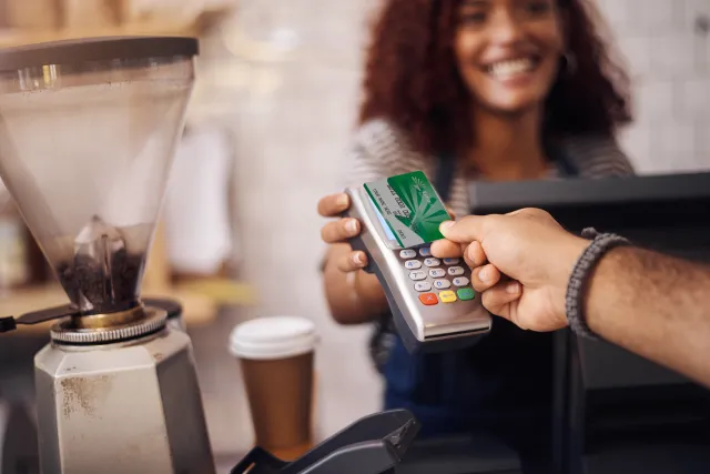 Man tapping debit card on terminal