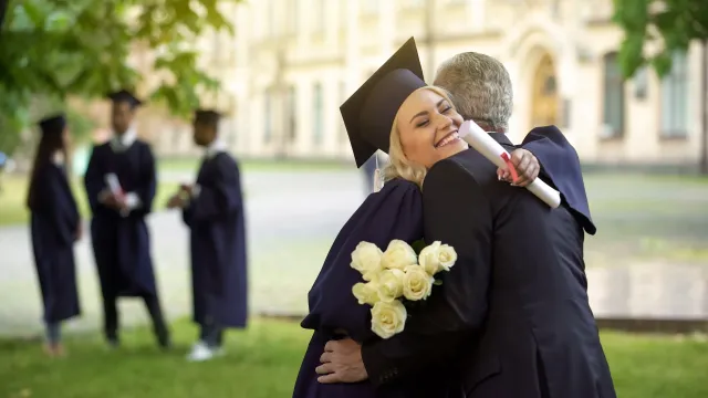 Graduate hugging father