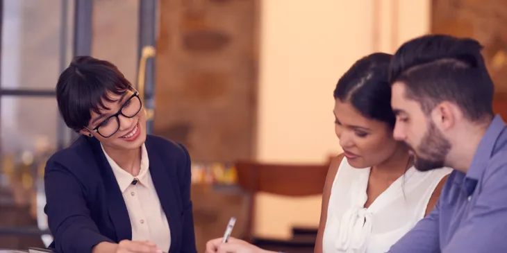 Young couple meeting with banker in office