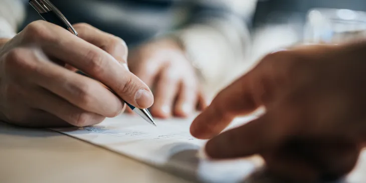 Close up of someone signing a contract