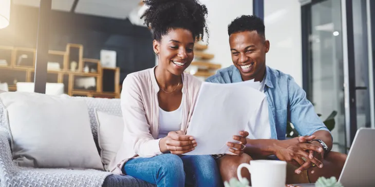 Smiling couple looking at paperwork