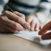 Close up of someone signing a contract